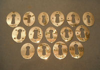 Long Run of Similar Pressed Brass Keyhole Surrounds   KC211